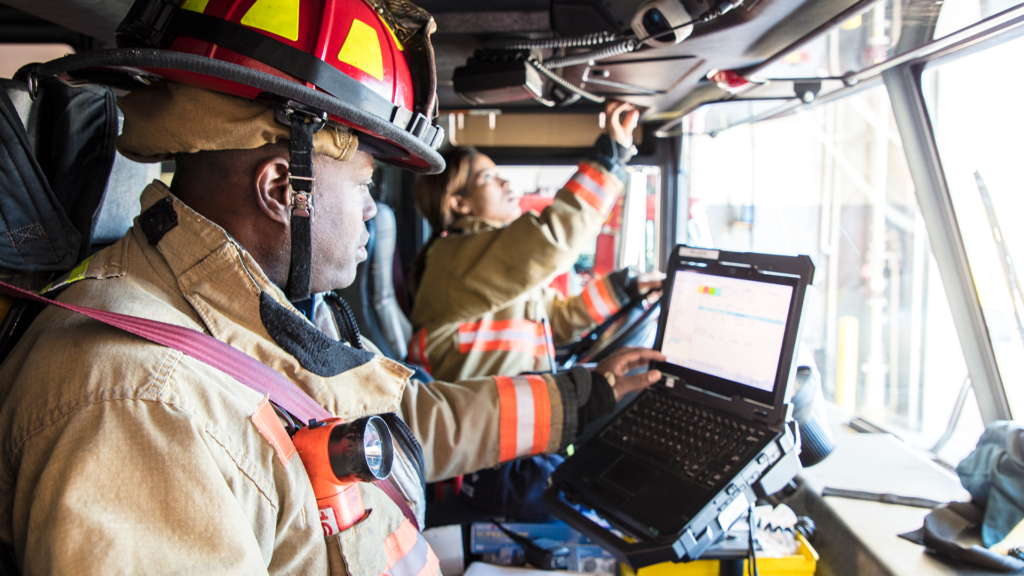 Firefighter using in-vehicle computer system.